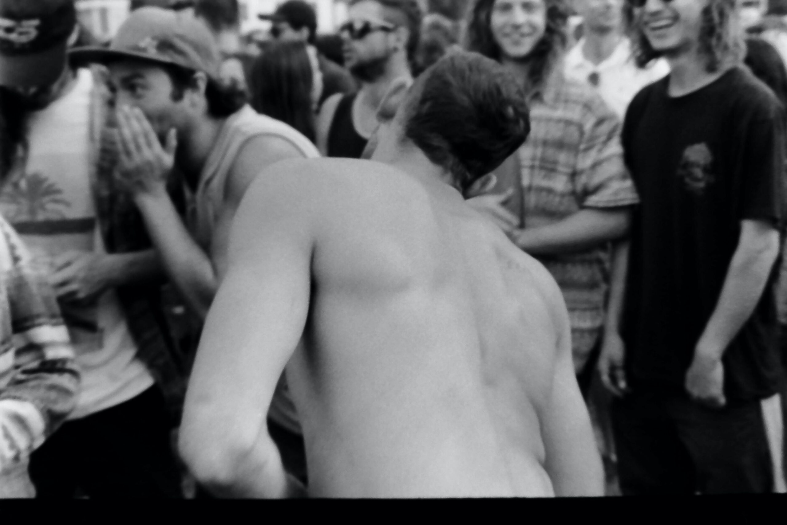 Vibrant crowd enjoying an urban street festival in England captured in black and white.